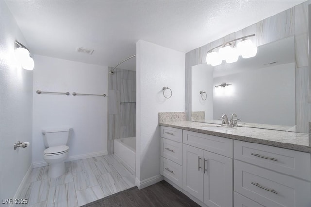 full bathroom with vanity,  shower combination, toilet, and a textured ceiling