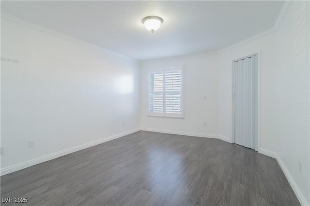 spare room with dark hardwood / wood-style floors and ornamental molding