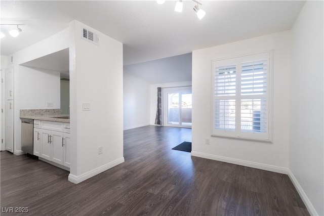 interior space with white cabinets, stainless steel dishwasher, and dark wood-type flooring