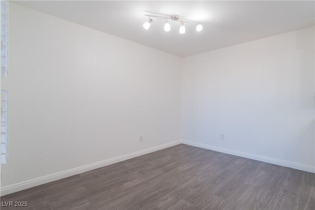 unfurnished room with dark hardwood / wood-style flooring