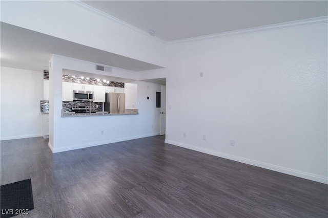 unfurnished living room featuring dark wood-type flooring and ornamental molding