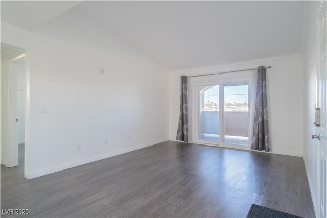 empty room with dark hardwood / wood-style flooring, lofted ceiling, and ornamental molding