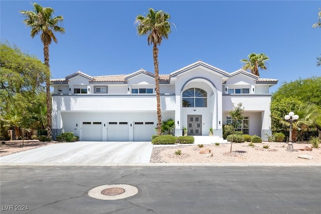 mediterranean / spanish home featuring a garage