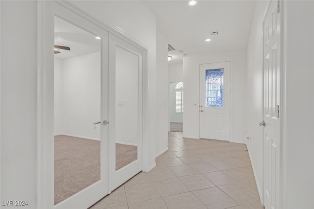 tiled entryway with ceiling fan