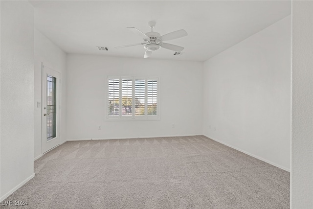 carpeted spare room with ceiling fan