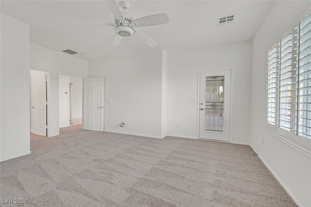 carpeted spare room with ceiling fan and a healthy amount of sunlight