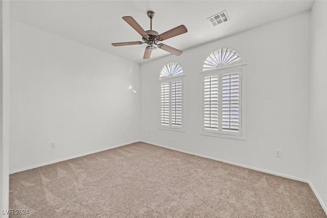 spare room with light colored carpet and ceiling fan