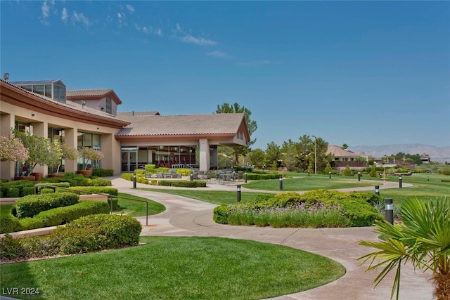 view of community with a lawn and a mountain view