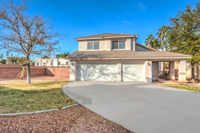 view of front of property featuring a front yard and a garage