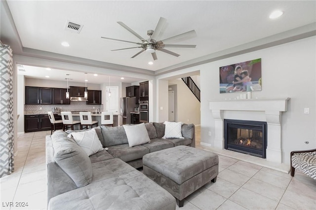 tiled living room featuring ceiling fan