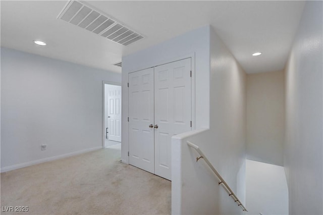 hallway with light colored carpet