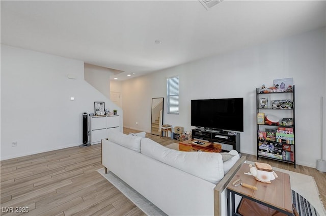 living room with light hardwood / wood-style flooring