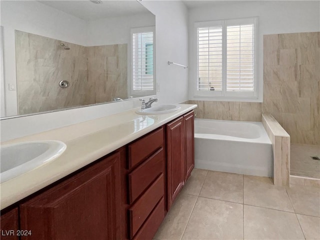 bathroom featuring tile patterned flooring, shower with separate bathtub, vanity, and tile walls