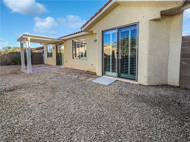 rear view of house featuring a patio area and a pergola