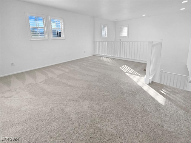 carpeted empty room featuring a wealth of natural light