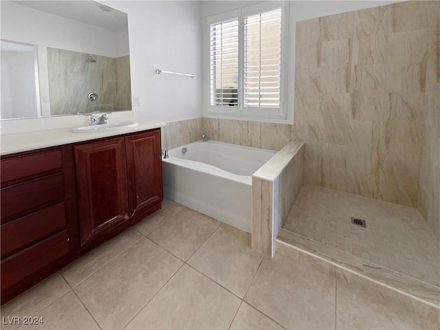 bathroom with tile patterned floors, vanity, plus walk in shower, and tile walls