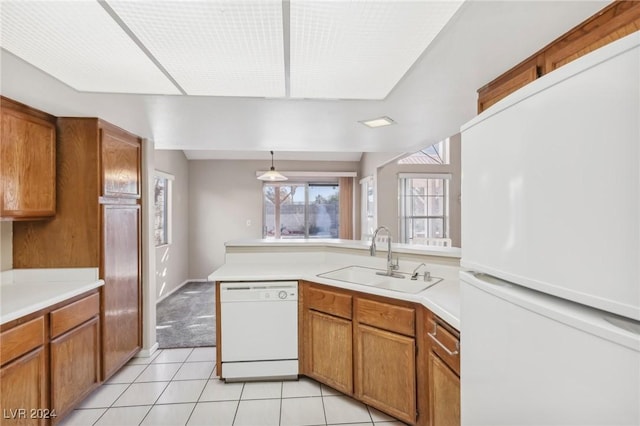 kitchen featuring pendant lighting, light tile patterned flooring, white appliances, and sink