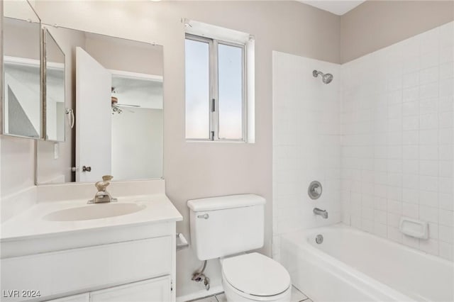 full bathroom featuring tiled shower / bath, vanity, toilet, and ceiling fan