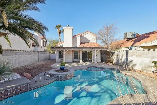 view of pool featuring central AC, an in ground hot tub, and a patio area