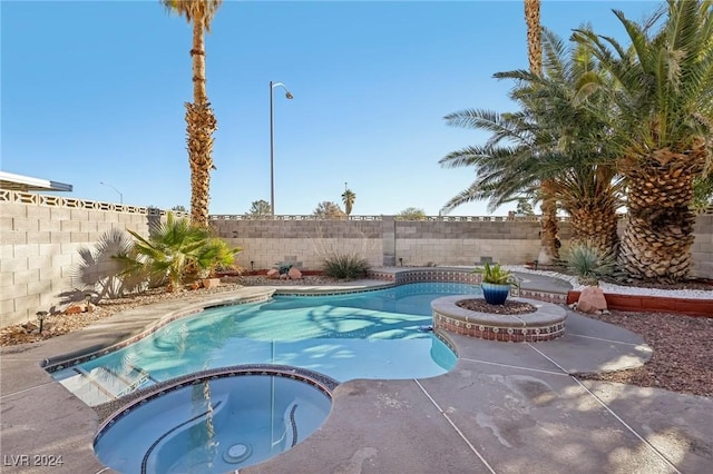 view of pool featuring an in ground hot tub