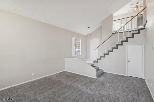 interior space featuring carpet flooring, ceiling fan, and high vaulted ceiling