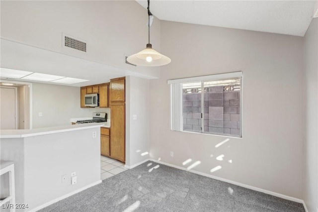 kitchen featuring light carpet, appliances with stainless steel finishes, decorative light fixtures, and kitchen peninsula