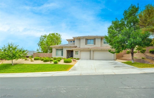 view of front of home with a front lawn and a garage