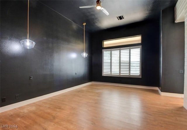 spare room with ceiling fan and wood-type flooring