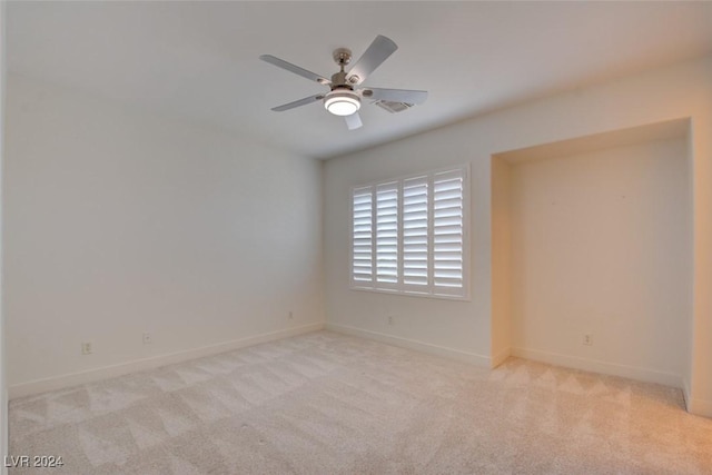 carpeted empty room with ceiling fan