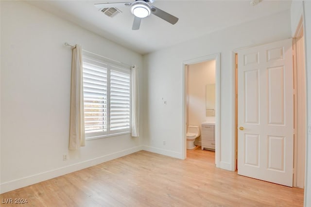 unfurnished bedroom with ceiling fan, light hardwood / wood-style floors, and ensuite bathroom