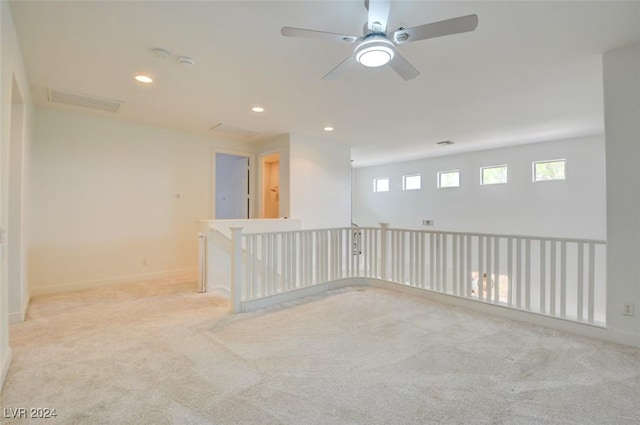 carpeted empty room featuring ceiling fan