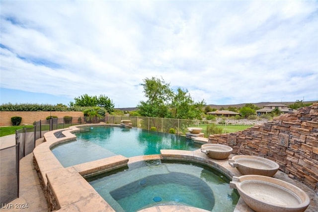 view of pool featuring an in ground hot tub