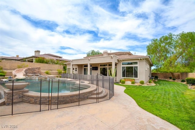 view of pool featuring a lawn, a patio area, and a jacuzzi