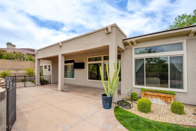 rear view of property featuring a patio