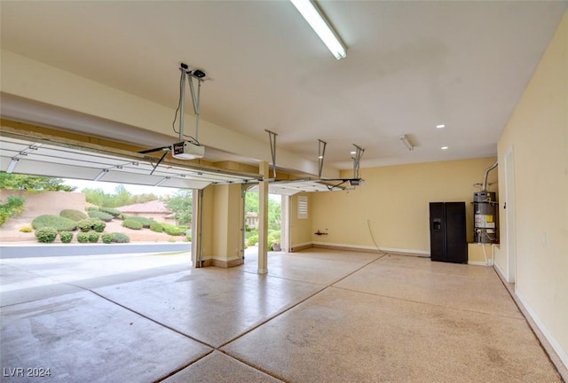 garage featuring water heater and a garage door opener