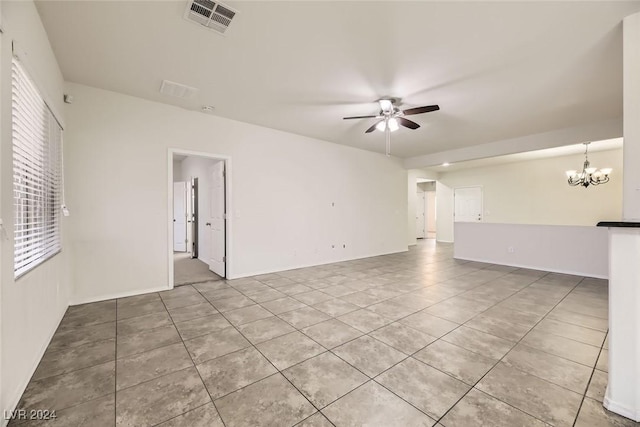 unfurnished room with ceiling fan with notable chandelier