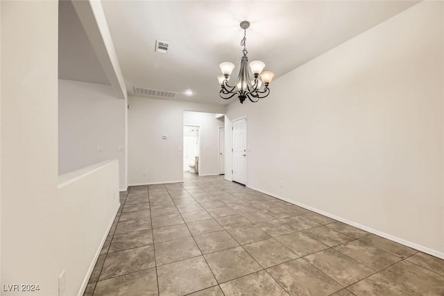 unfurnished dining area featuring tile patterned flooring and a chandelier