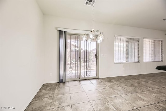 unfurnished dining area with a chandelier and tile patterned floors