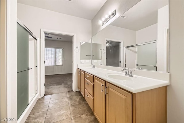 bathroom with tile patterned floors, vanity, and ceiling fan