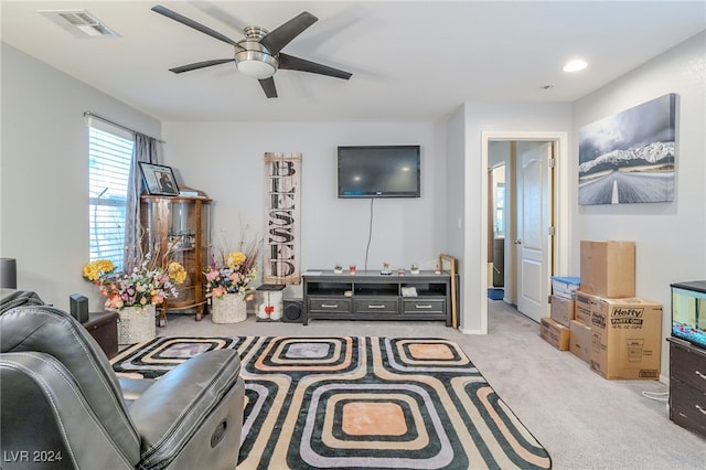 carpeted living room featuring ceiling fan