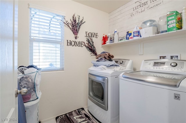 clothes washing area with washing machine and dryer