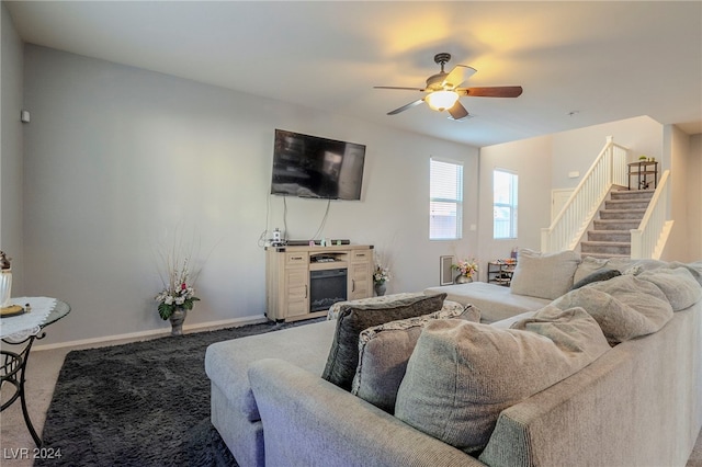 living room featuring carpet flooring and ceiling fan