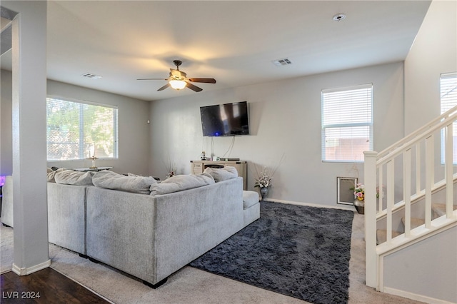 living room with hardwood / wood-style floors, a wealth of natural light, and ceiling fan