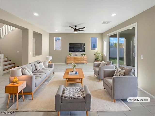 living room with ceiling fan and light tile patterned flooring