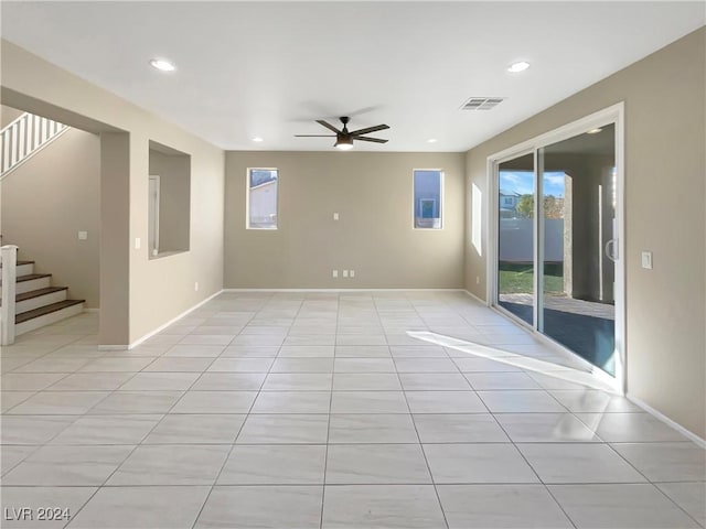 spare room featuring ceiling fan and light tile patterned flooring