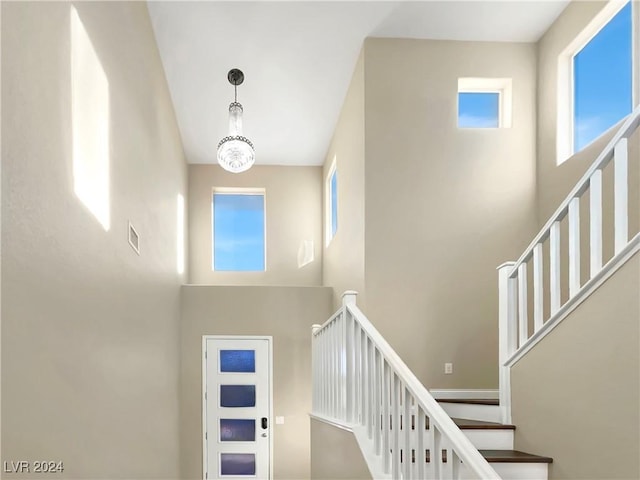 stairs featuring an inviting chandelier