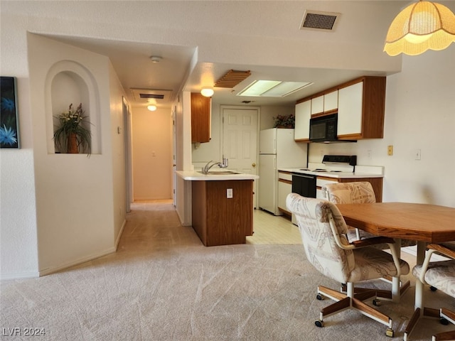 kitchen with kitchen peninsula, light colored carpet, white appliances, and sink