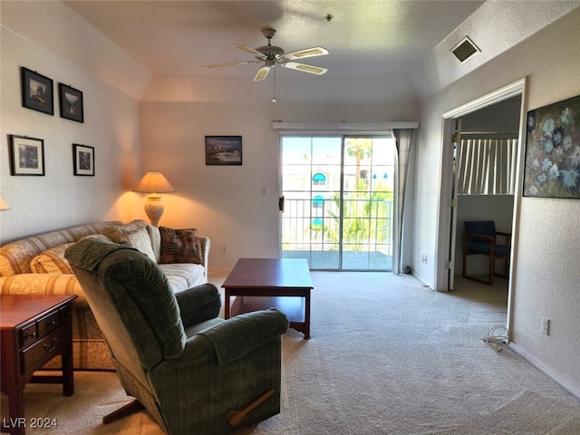 carpeted living room featuring a textured ceiling, vaulted ceiling, and ceiling fan