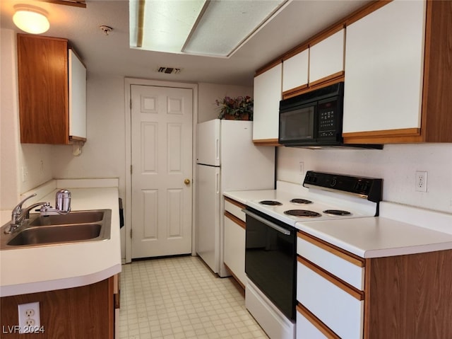 kitchen featuring white cabinetry, white range with electric cooktop, and sink