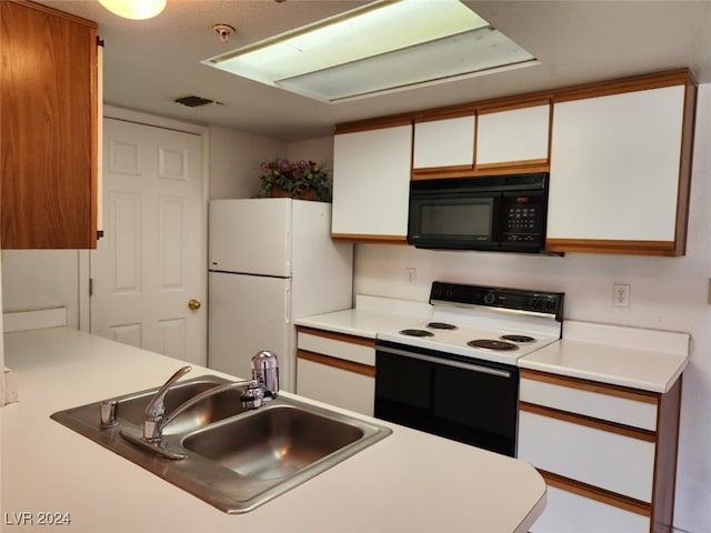 kitchen featuring white cabinets, white appliances, and sink